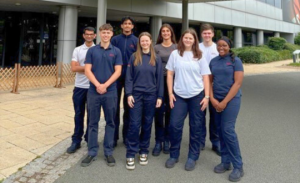 2025 NUBS graduate Maya with her team standing outside the Toyota office