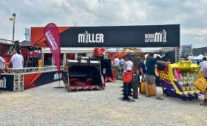 The Miller Groundbreaking space at a trade show, with banners and digger buckets